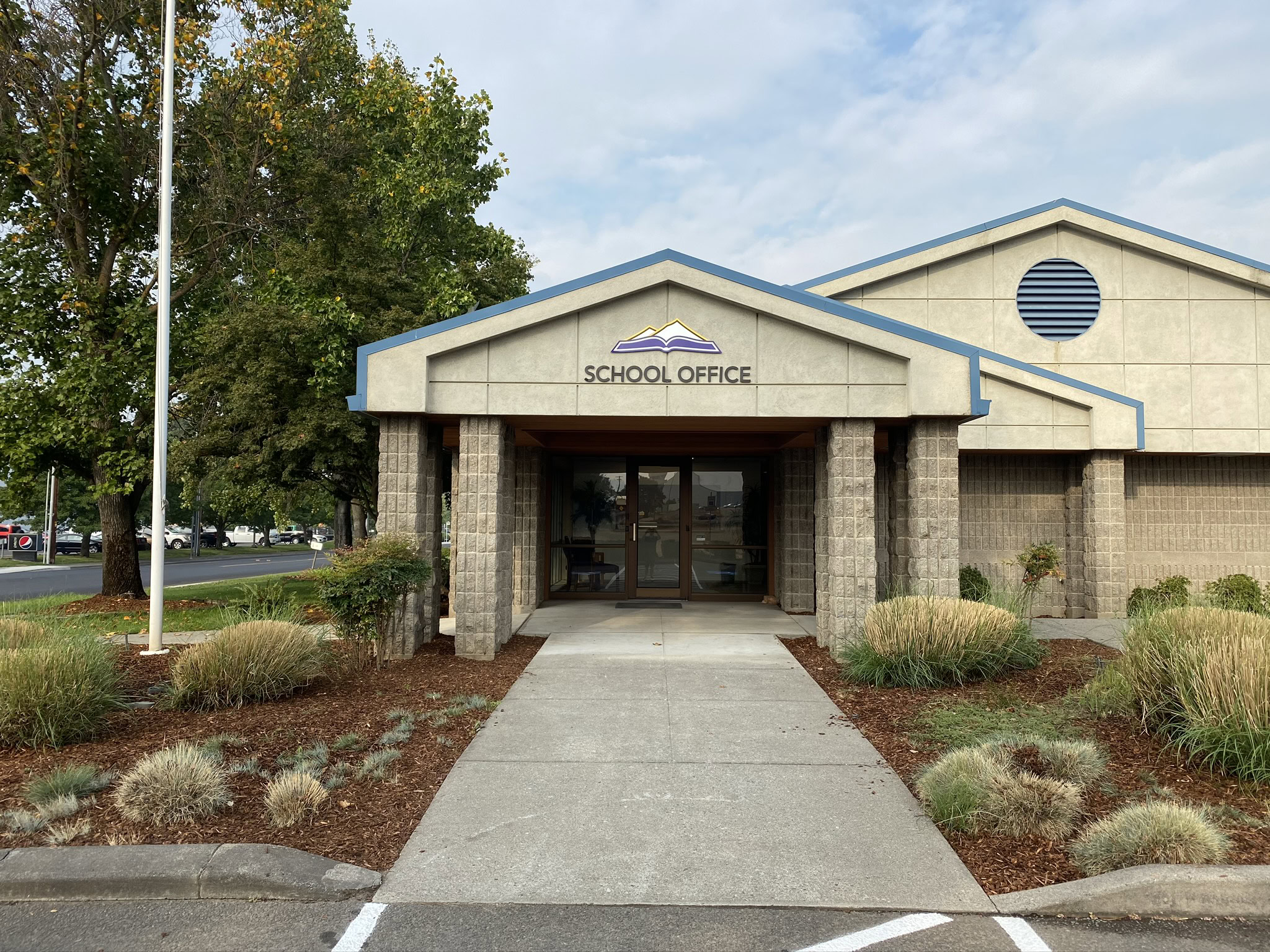 School office building with a sign reading 'School Office' in Medford, Oregon.