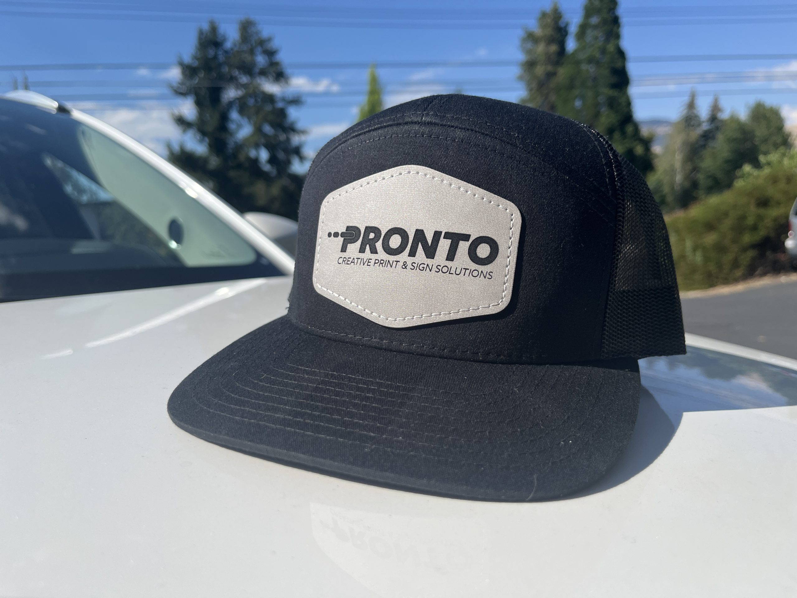 Black cap with Pronto Print Medford logo for promotional use.